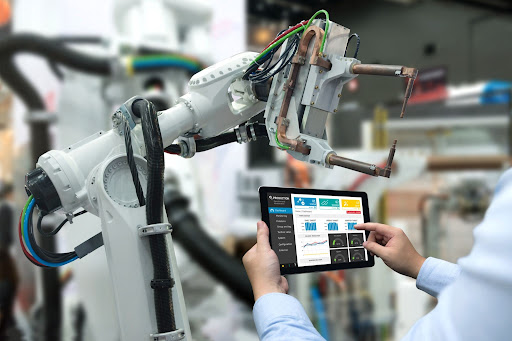 Man controlling robotic arm with a tablet