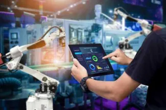 Employee in from of robotic arm