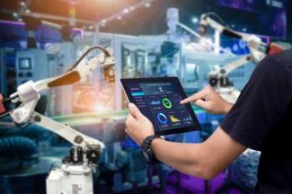 Employee in from of robotic arm