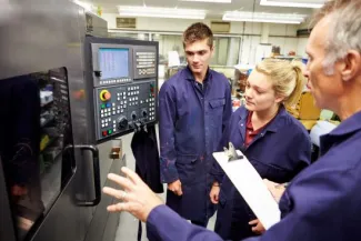 Employees in from of a control panel