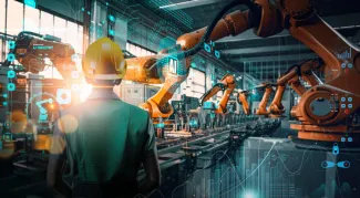 Technician working with automated robotic arm